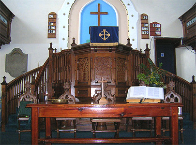 Image The monument commemorating John and Susanna Dando<br>hangs on the wall to the left of the pulpit inside the current Dursley Tabernacle